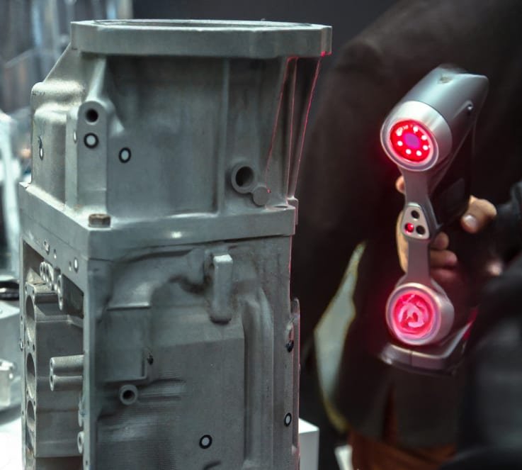 Handheld laser 3D scanner digitising an aluminium gearbox casing